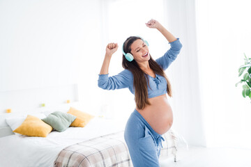 Photo of overjoyed glad positive lovely pregnant girl future mommy dancing alone enjoying good mood white light room interior indoors