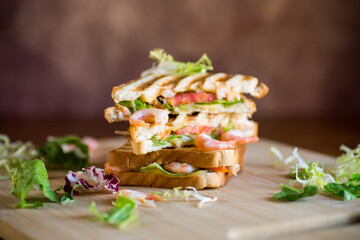 sandwich with lettuce and shrimp. - obrazy, fototapety, plakaty