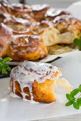 cooked baked sweet Cinnabon with cream in baking paper .