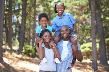 Travel, portrait or black family hiking in forest to relax or bond on holiday vacation together in...