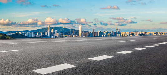Asphalt highway road and city skyline with modern buildings at sunset in Zhuhai, Guangdong Province, China. Panoramic view.