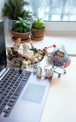 Work desk with laptop, set of minerals, Buddha figurine on table. Magic crystal ritual for energy,...