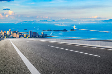 Asphalt highway road and beautiful coastline natural landscape at sunset in Zhuhai, China. High angle view.