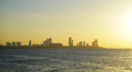 Silhouette of Pattaya city with seaside view and sunset sky background, Travel background