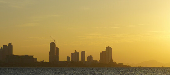 Silhouette of Pattaya city with seaside view and sunset sky background