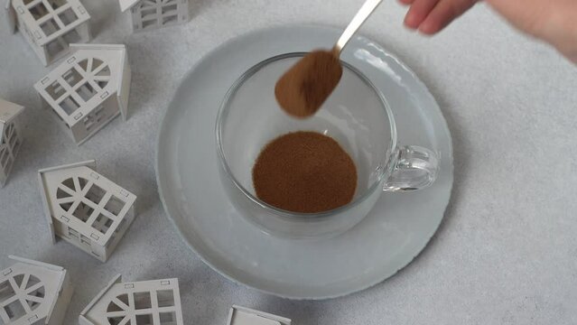Pour chicory or instant coffee into a transparent cup. Preparing a hot drink.