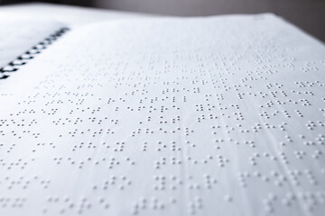 Reading a book in Braille - obrazy, fototapety, plakaty