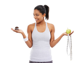 Woman, apple and cake choice for diet in studio for weight loss decision, healthy eating or white background. Female person, hands and fruit or cupcake as mockup or tape measure, training or wellness