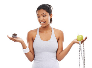 Woman, apple and cupcake decision for diet in studio for weight loss choice, healthy eating or...
