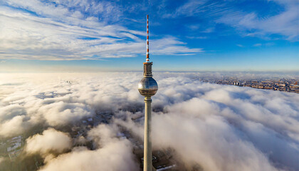 Bird's-eye View of the Television Tower Piercing Through the Clouds in Berlin - obrazy, fototapety, plakaty