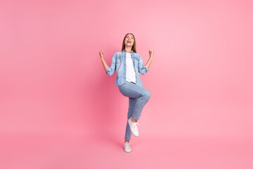 Full body photo of attractive young woman raise fists winning scream dressed stylish denim clothes...