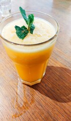 glass of fresh sun kist orange juice on wooden table