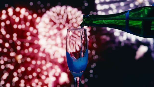 Unrecognizable person pouring champagne into the glass. Shot with RED helium camera in 8K.  