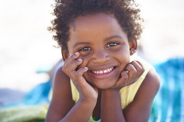 Happy, african child and portrait on beach sand, relax and summer holiday with sunshine in nature....