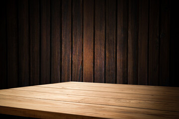 image of a wooden table on an abstract dark background with light in the center