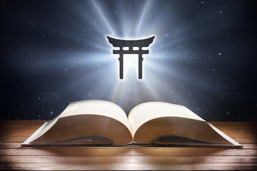 Open book on wooden table and shintoism symbol front view