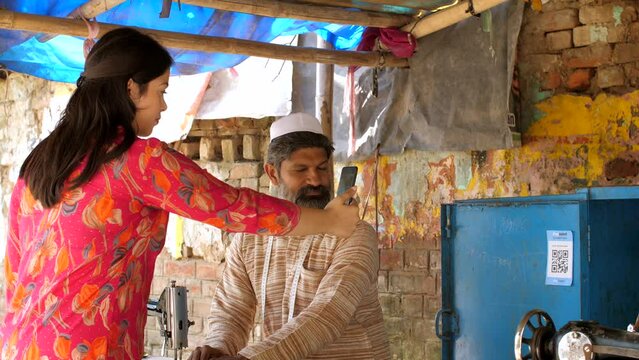 An Indian woman making an online payment using UPI barcode scanner - mobile app payment  Indian digital payment. A young office-going girl using app for payment - digital transaction  digital payme...