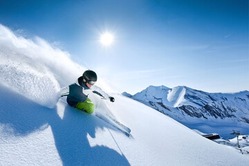 wonderful skiing in perfect powder snow condition in the Alps on a sunny day. - obrazy, fototapety, plakaty