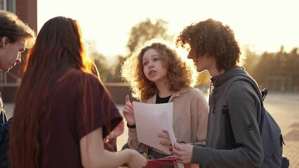Young students talking near school