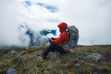 Hiking woman use smart phone taking photo on high altitude mountains - obrazy, fototapety, plakaty