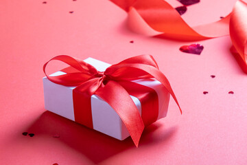 valentine red ribbons, confetti and gifts on red background