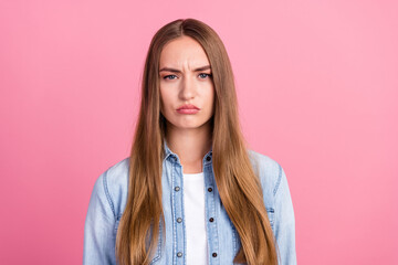 Fototapeta premium Photo portrait of attractive young woman sad moody facial expression dressed stylish denim clothes isolated on pink color background