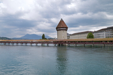 View of the Chapel Bridge and the Wasserturm (water tower) on river Reuss in historic city of...