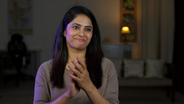 A young Indian woman applauding - smiling  appreciation  presentation at a conference  proud gesture. A woman appreciates and claps with a respectful expression on her face - congratulating  nodding
