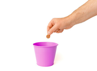 The euro coin is thrown into the trash basket.White isolated background,selective focus