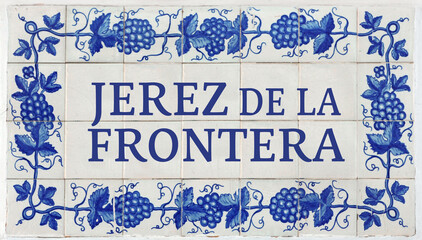 Jerez de la Frontera on Frame of Azulejos (name of Spanish tiles) with blue bunches of grapes