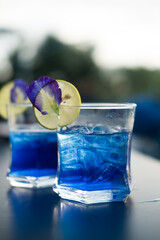 Herbal healthy drinks mix lemon and flower butterfly pea purple cold cocktail. Close up