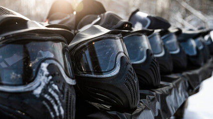Paintball masks lay in a row in winter on the street