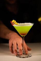 Alcoholic cocktail on a black background. Concept of cocktails and alcohol