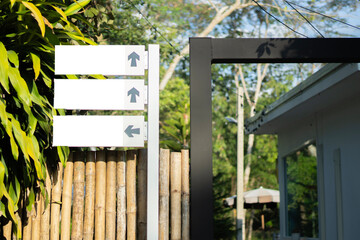 Fototapeta premium Three empty directional arrow information panel path trail marker display board signage with trees background