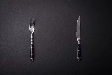 Fotobehang Kitchen knife and fork made of steel with copy space © chernikovatv