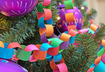 Garland-chain made of colored paper on Christmas tree. Christmas and New Year's decor.