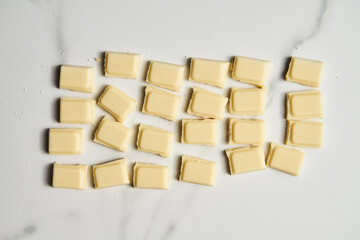 White chocolate bar on white marble background. 