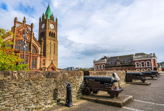 The Guildhall in Derry-Londonderry, Northern Ireland, built in the 19th century with red bricks and the clock tower, meeting place of the local city council, seen from the walls.