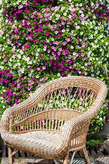 wicker chair on a flower wall background