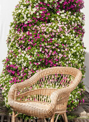 wicker chair on a flower wall background