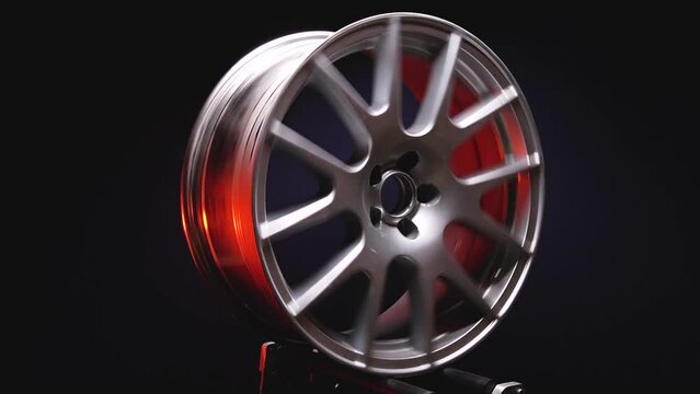 stylish car titanium rims in silver color in red light in dark room