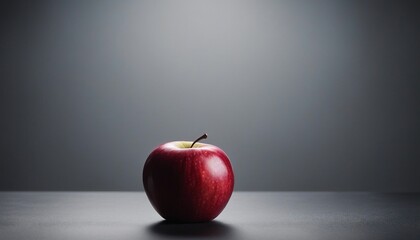 Red apple on grey background. Copy space. Healthy food concept.