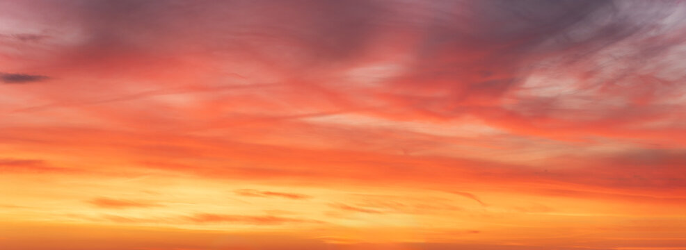 Wide-format, red sunset or sunrise, sky with a multitude of vibrant color shades.