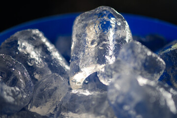 Ice cubes in blue bucket. Close up
