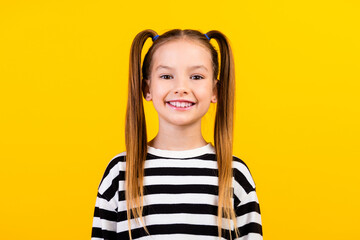 Photo of sweet good mood little child dressed striped pullover smiling isolated yellow color background