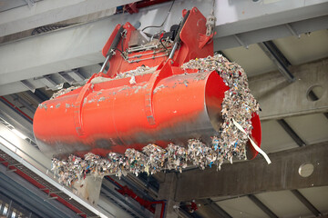 Detalied view of jaws of red grab. Handling and Transportation of fuel obtained from waste (RDF) by red grab to the boiler for combustion.  Processing of municipal solid waste into an energy source.