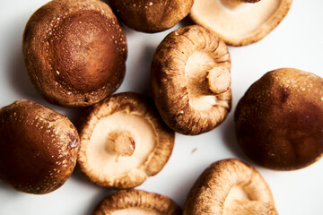 Raw Shiitake mushrooms on white marble background