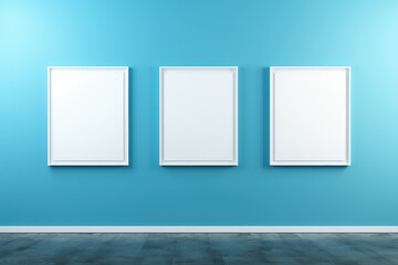 blue interior wall with three mockup image frames