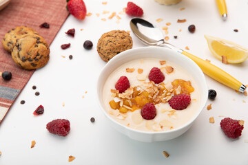 Yogurt with berries and almonds in a white bowl