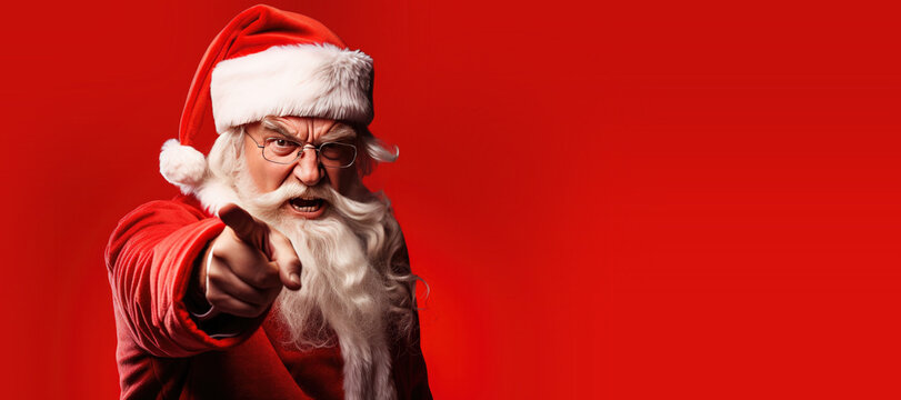 Angry Christmas Santa Claus Pointing his Finger at You on a Red Background with Space for Copy